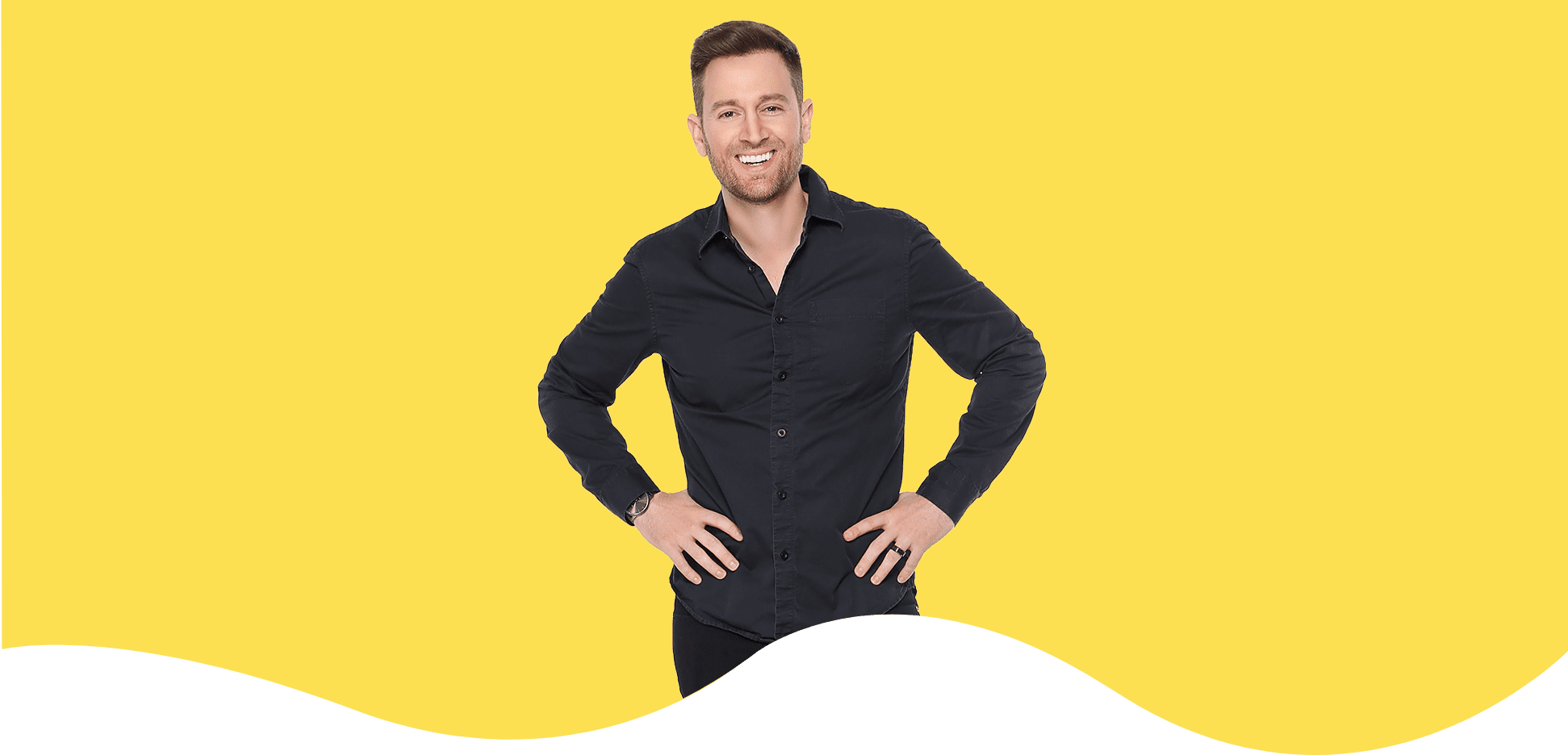 Smiling man in black shirt against yellow background. Smiling man in black shirt against yellow background.